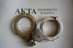 policyjne kajdanki i akta sprawy