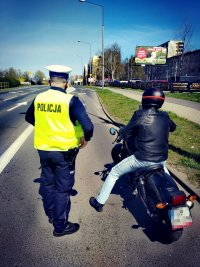zdjęcie kolorowe: policjant podczas kontroli motocyklisty