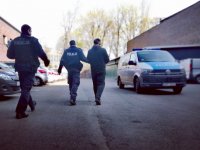 zdjęcie kolorowe: policjanci z osobą zatrzymaną