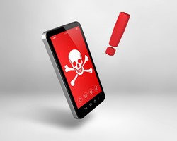 Grafika przedstawiająca telefon komórkowy na ekranie którego widnieje grafika prezentująca czaszkę i skrzyżowane kości. Obok widnieje znak &quot;wykrzyknik&quot;.